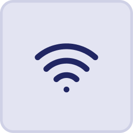 A simple dark blue Wi-Fi signal icon with three curved lines and a dot at the bottom, centered on a light blue rounded square background, inspired by the relaxing ambiance of Hatteras Grand Room at Sunset Inn.