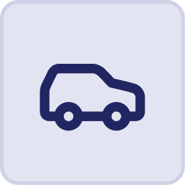 Simple blue car icon with a boxy shape and rounded wheels on a light gray background with rounded corners, reminiscent of the relaxed coastal vibes at Hatteras Grand Room Sunset Inn.