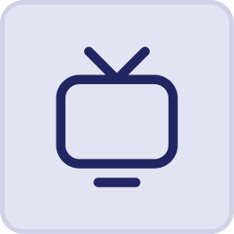 Simple dark blue icon of a retro television with two antennae on top, displayed on a light background with rounded corners—evoking the nostalgic charm of evenings in the Hatteras Grand Room at Sunset Inn.